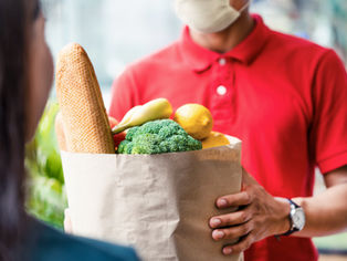 A bag of groceries handed to a buyer