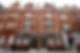 Elegant brick townhouses lining a street in a wealthy London neighborhood