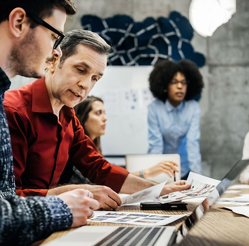 A group of people holding a Business Meeting