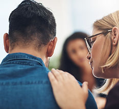 A woman consoling a man during a session