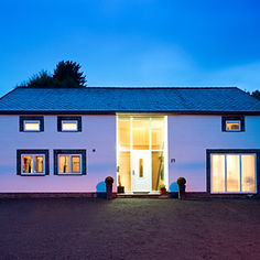 house at dusk with an illuminated porch