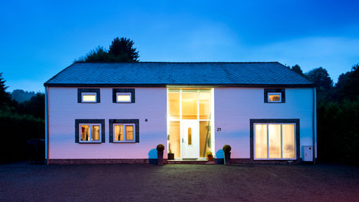Beautiful suburban home with a manicured lawn and clear blue sky, symbolizing homeownership and mortgage benefits.