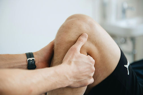 Physical therapist working on a patient with knee pain