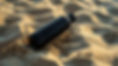 Black Bottle On Sand