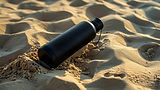Sort flaske på sand