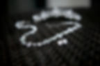 Close-Up Of Diamond Necklace And Earring On Table