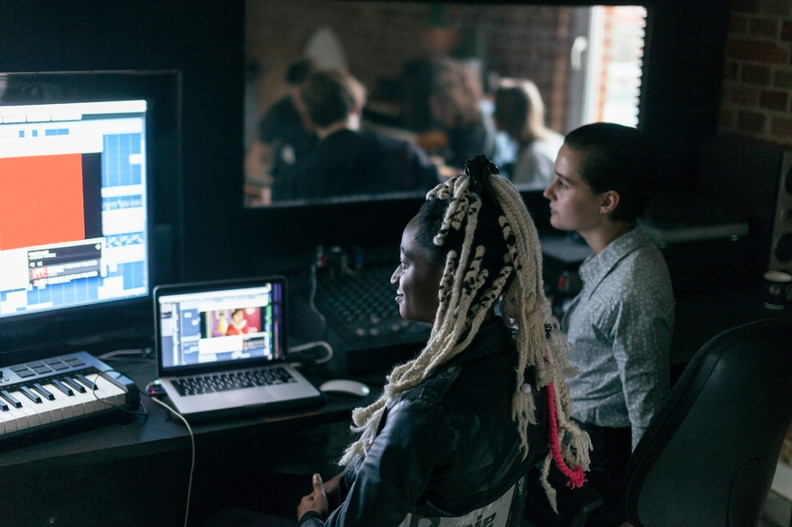 Students look over edits on a computer.
