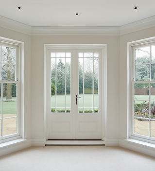 a beautifully crafted set of Georgian style white wooden bay windows with French doors