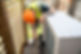 Professional performing heat pump installation service outside a home.