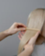 Hair dresser combing through hair