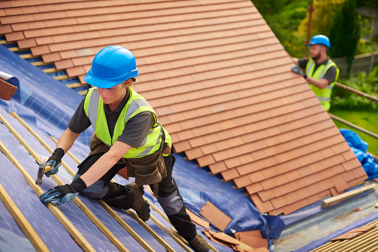 Roofer nails on the roof tiles
