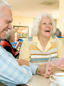 Two residents in a retirement home playing cards