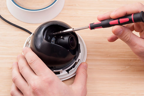 technician repairs CCTV camera on the table