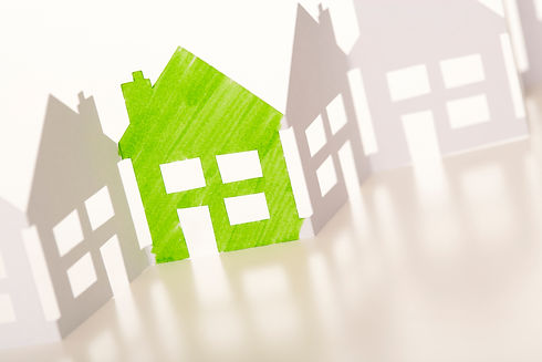 a green paper cutout of a house