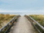 A scenic pathway leading to a beach, representing the personalized journey toward holistic wellness and restorative health.