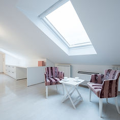 Interior of a bright white room loft with chairs