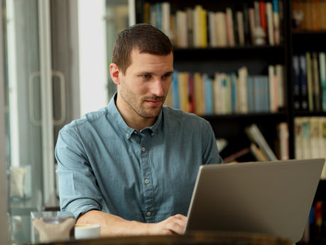 a man looking on a laptop
