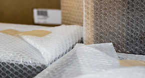 Moving the house - close up of household objects wrapped in bubble wrap ready to be moved