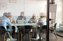 Professionals meeting around a conference table.