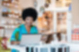 Store Owner Using Laptop