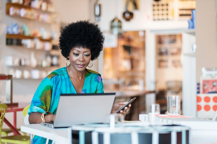 Store Owner Using Laptop