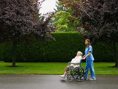 Nurse pushing patient in wheelchair