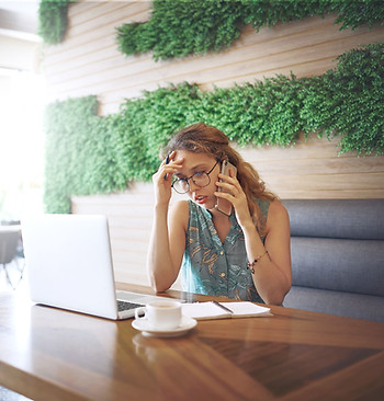 Woman listening to her phone at a coffee shop