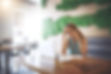 Woman listening to her phone at a coffee shop