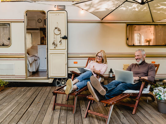 Couple planning retirement finances while comparing Gold IRA and physical gold options