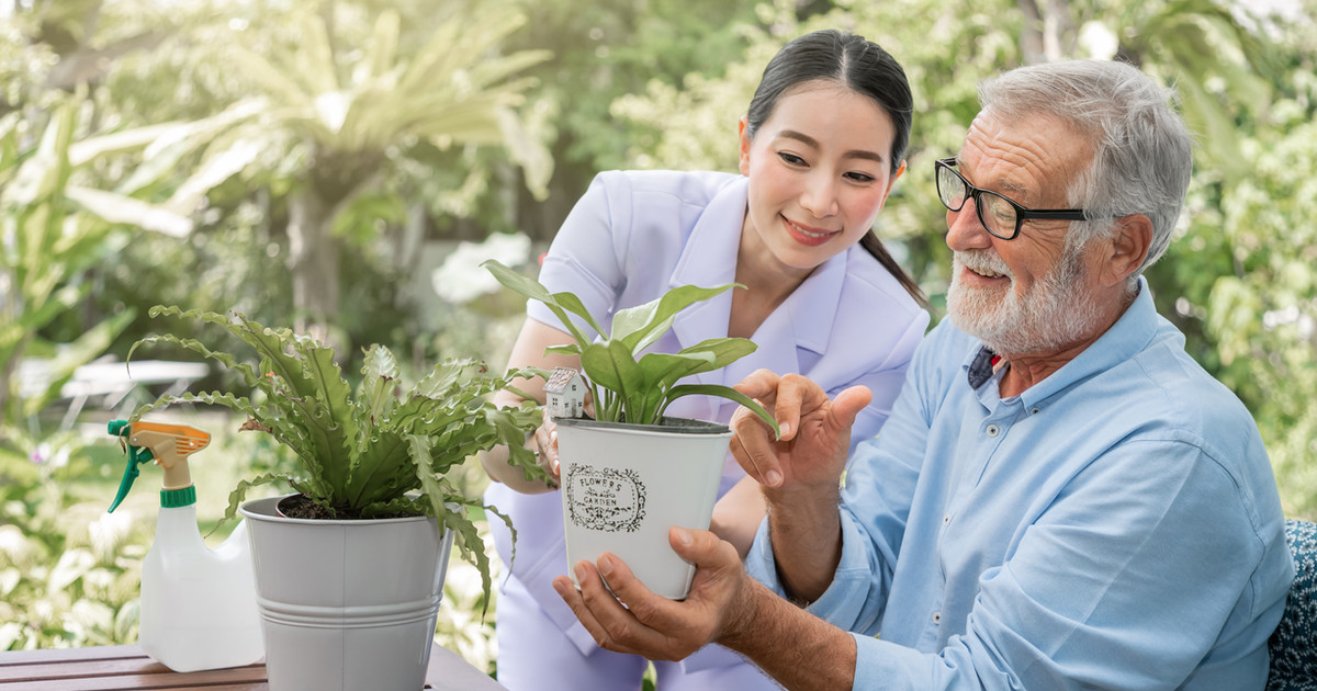 A person gradually returning to gardening one small step at a time, rebuilding confidence and function through graded exposure.