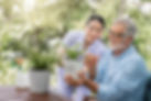 Nurse and elderly man taking care of plants