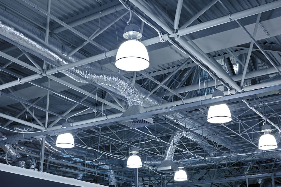 Overhead view of an industrial ceiling featuring exposed ductwork and ventilation systems