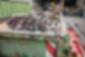A waste container full of waste on the site of a waste recycling centre