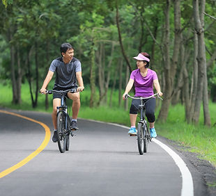 A man and a woman riding bikes