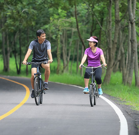 A man and a woman riding bikes