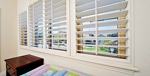 Elegant tier on tier plantation shutters offering adjustable light control and privacy