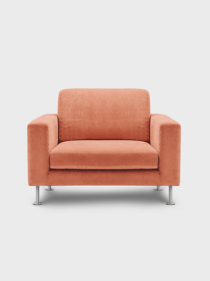 Orange upholstered chair in the welcoming office of Creating Space Therapy, representing comfort and care in therapy sessions.