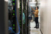 Hispanic technician working in computer server room