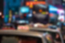 Taxis with illuminated signs in a bustling city at night