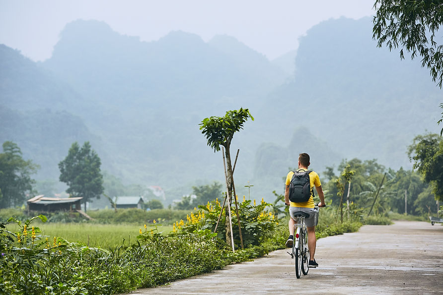 Man biking in Vietnamese countryside