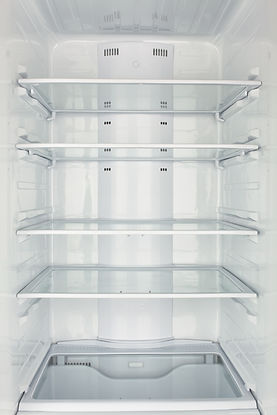 An open, empty refrigerator with three clean glass shelves