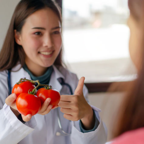 A doctor prescribing produce in alignment with Food is Medicine
