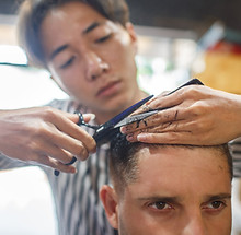 Man getting a haircut at a Vietnamese barber shop