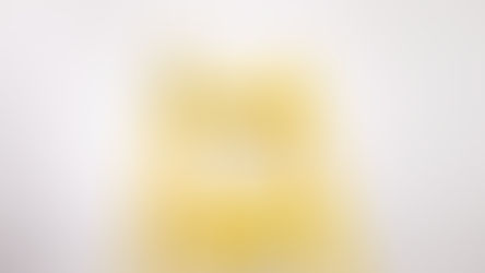 Close-up image of the top two rungs of a bright yellow ladder against a neutral background, symbolizing upward progress or steps in a Roth IRA conversion ladder strategy.