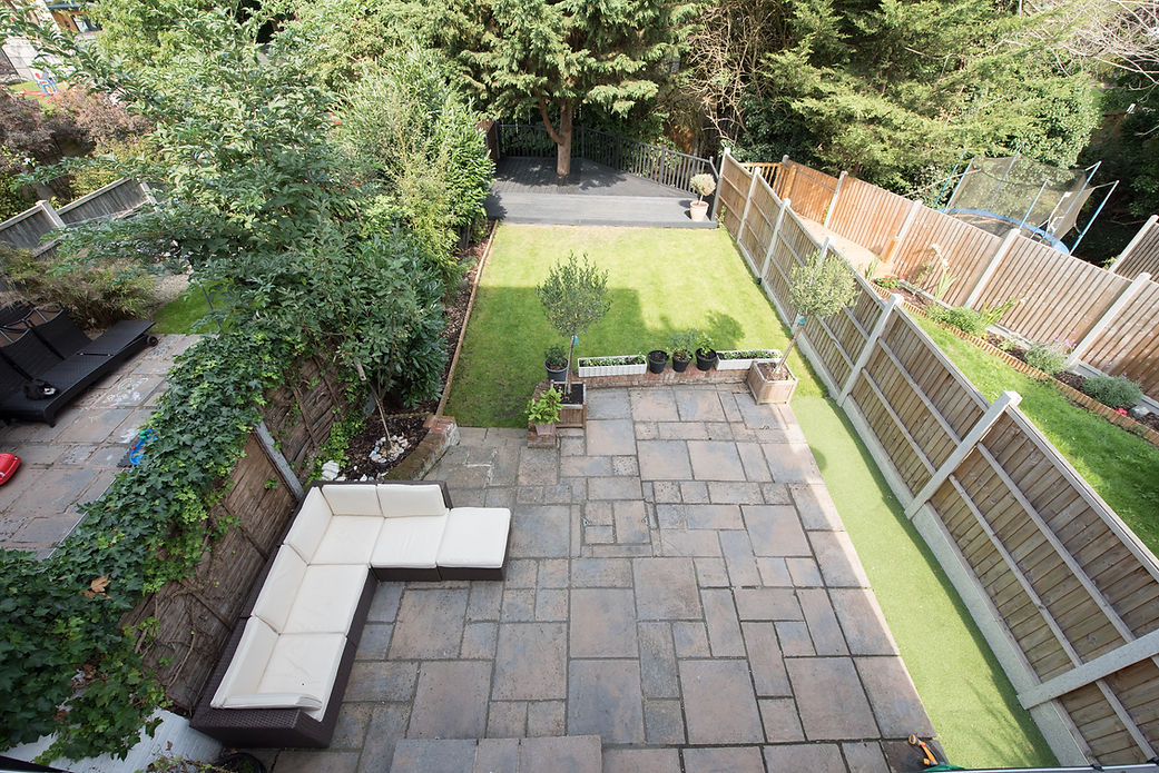 top view of a garden with patio area and fence