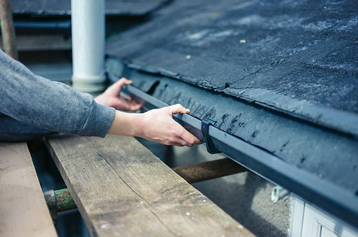 a person's hand and gutter pipe