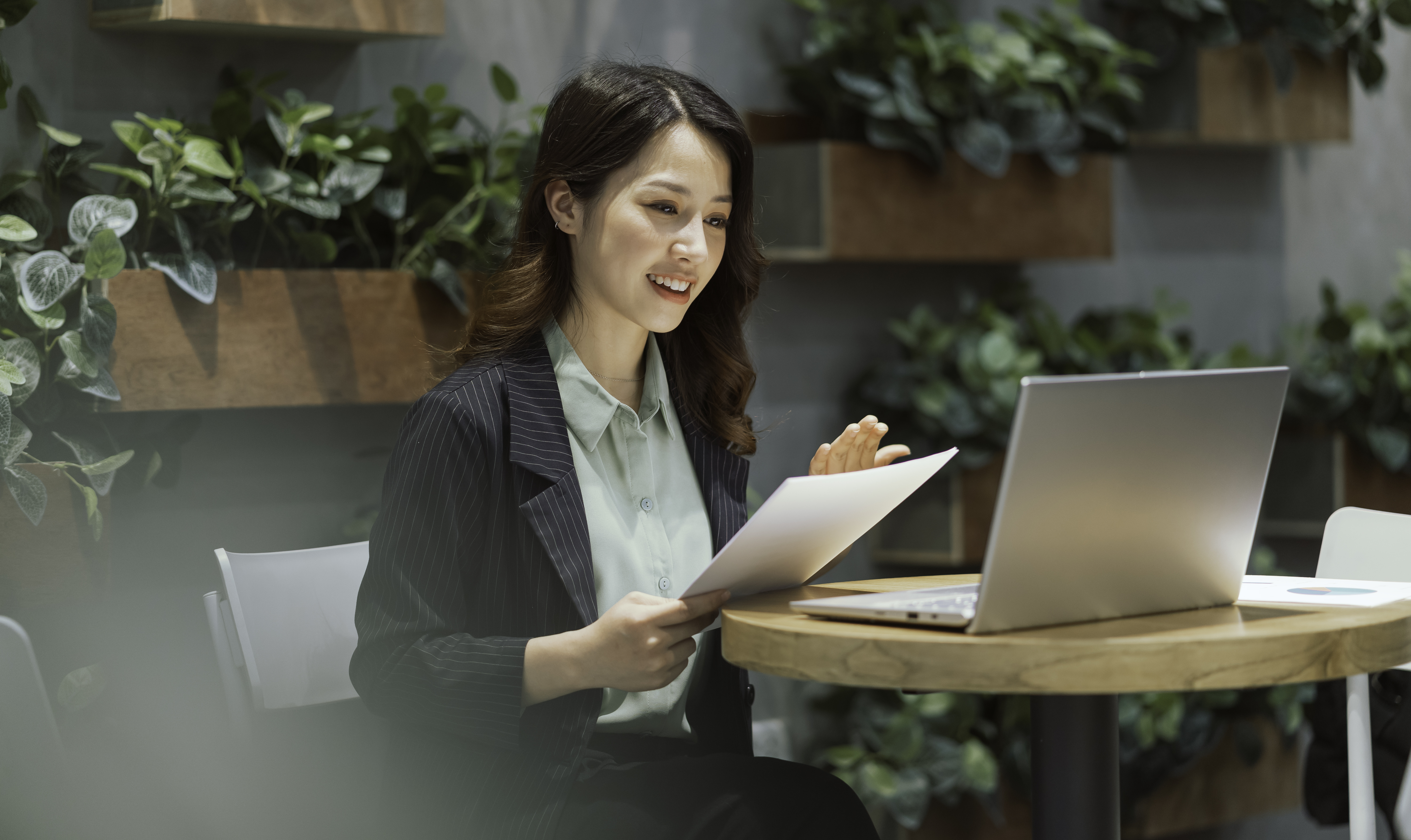 Asian woman having an online meeting on laptop