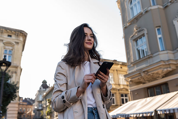 woman smiling looking off holding phone