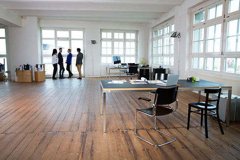 Group of business people standing together by an office window