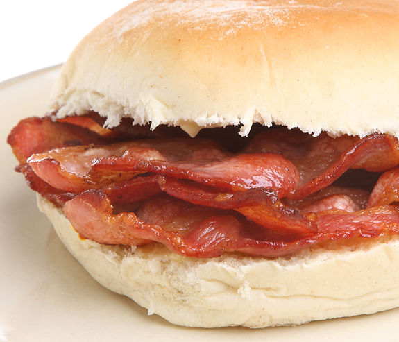 Crispy bacon in a soft white bread bap